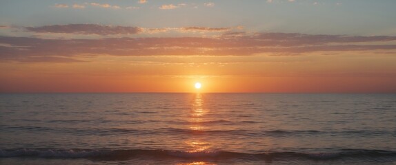 Fototapeta premium Sunset over calm ocean waters with colorful sky and reflection on water surface, tropical beach landscape, wide horizontal orientation, Copy Space