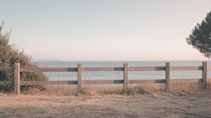 Coastal wooden fence overlooking ocean at sunset