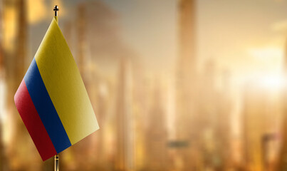 Small flags of the Colombia on an abstract blurry background