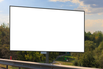 Fototapeta premium White billboard along the highway. Background for design and advertising. 