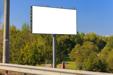 Background for design, white billboards on city streets and along roads in the summer day
