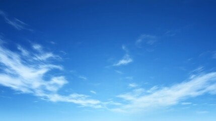 Obraz premium A Vivid Blue Sky With Wispy White Clouds