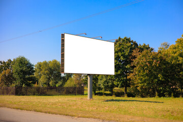 Background for design, white billboards on city streets and along roads in the summer day