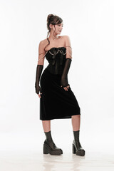 Young beautiful girl brunette of an eastern outbreak of black dress on a white background