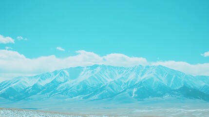 Snow capped mountains under a vibrant blue sky