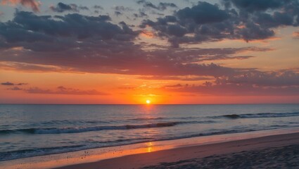 Obraz premium Sunset over calm ocean waves with colorful sky and sandy beach, vibrant hues of orange and blue, Copy Space for text placement.
