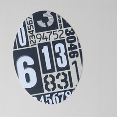 machine-cut oval shape with numbers on blank paper