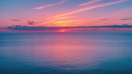 Obraz premium Colorful sunset over calm ocean water with clouds and reflective surface in a tranquil seascape landscape Copy Space