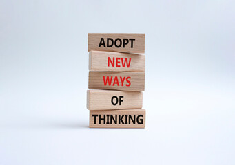 Adopt new ways of thinking symbol. Wooden blocks with words Adopt new ways of thinking. Beautiful white background. Business and Adopt new ways of thinking concept. Copy space.