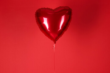 Heart-shaped balloon on red background. Valentine's day