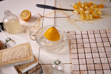 the process of preparing a natural cleaning product with lemons for cleaning the house, still life top view