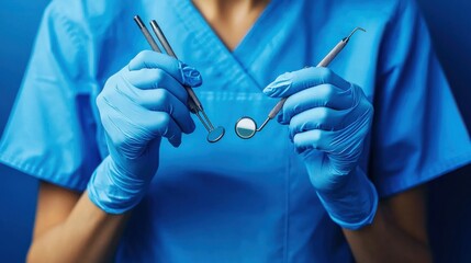 Close-up of a dentist holding dental tools in blue gloves.