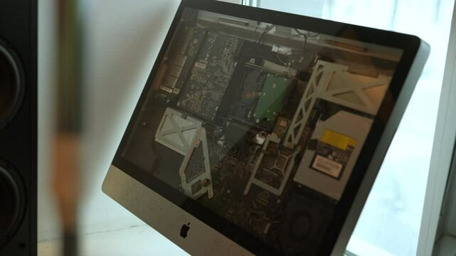 Ufa, Russia - 21 January 2025. Closeup of iMac computer without display showcasing internal components, including motherboard, graphic card, other electronic parts, unique view into complex technology