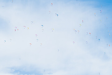 Sky with colorful paragliders in flight