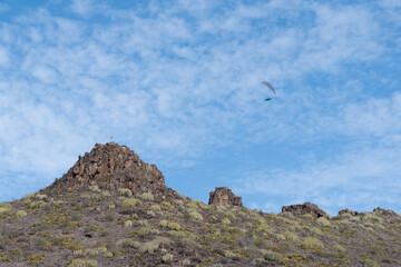 Fototapeta premium High-altitude adventure a paraglider near stunning cliffs