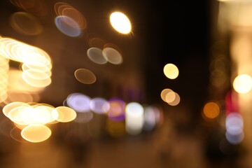 Fototapeta premium Blurred view of city street at night. Bokeh effect