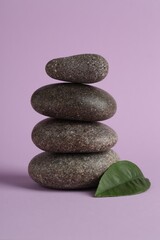 Stack of rocks on lilac background. Harmony and life balance