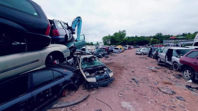 Car scrapyard with damaged vehicles.