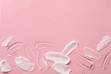 Samples of different cosmetic products on pink background, flat lay. Space for text