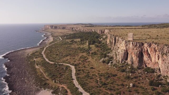 Aerial drone view of Macari (Makari), Sicily. Crystal clear turquoise waters, rugged cliffs, golden sandy beaches. A serene natural landscape with Mediterranean charm near San Vito lo Capo.	