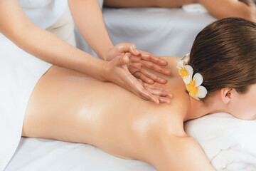 Obraz na płótnie Canvas Caucasian woman customer enjoying relaxing anti-stress spa massage and pampering with beauty skin recreation leisure in day light ambient salon spa at luxury resort or hotel. Quiescent
