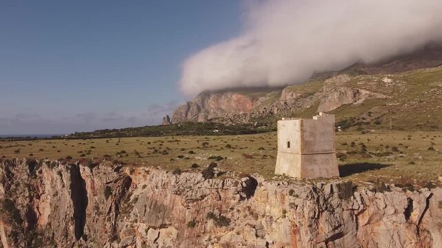 Aerial drone view of Macari (Makari), Sicily. Crystal clear turquoise waters, rugged cliffs, golden sandy beaches. A serene natural landscape with Mediterranean charm near San Vito lo Capo.	