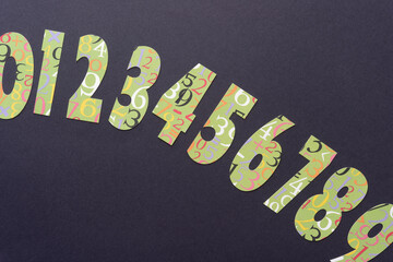 numbers machine-cut from scrapbooking paper with number prints on black