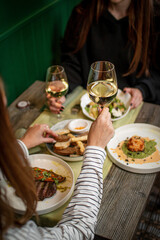 Elegant Dining Moment with Wine, Gourmet Dishes, and Fine Company