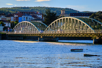 Historic iron bridge spanning over calm river