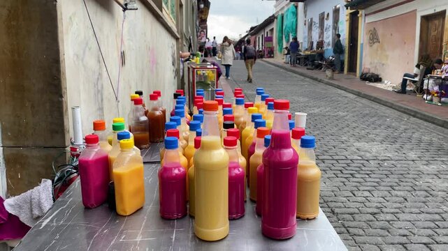 Street vendor sells bottles of Chicha, a indigenous fermented beverage, at La Candelaria, historic neighborhood in Bogota, Colombia.