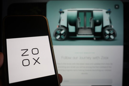 Roosendaal, The Netherlands - February 15, 2025: A mobile phone displaying the logo of Zoox, with the company website in the background.