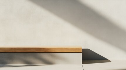 Minimalist wooden platform against a light wall with sun shadows.