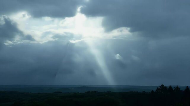 Atmospheric HD video showcasing dramatic storm clouds pierced radiant sunbeams capturing dynamic contrast light darkness moody ather filled sky