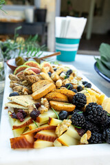 Appetizers with cheese, crackers, olives and fruits