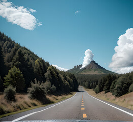 Mountain road in the forest at sunset in autumn. Top view from drone on the road in the forest. Beautiful landscape with a road in the hills, pine trees, green meadows, golden sunlight in autumn. Trav