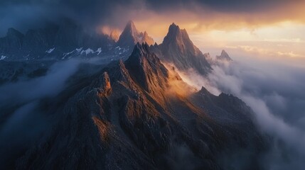 National Geographic A dramatic sunrise over jagged mountain peaks covered in mist.