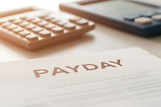 A close-up of a paycheck document with calculators in the background, symbolizing finance, earnings, and work compensation.