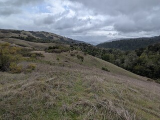 landscape of hills and mountains on a stormy day