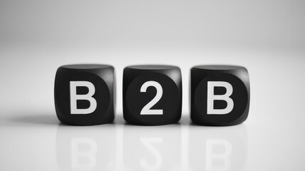 Three black dice spell out business to business acronym