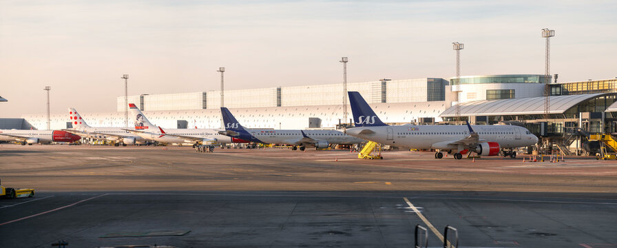 Kastrup, Denmark - 01-20-25: Cold winter evening at CPH Airport, Copenhagen, Kastrup lufthavn. Panorama of SAS and Norwegian planes standing at gates at Kastrup airport, area of Gates A, terminal 1