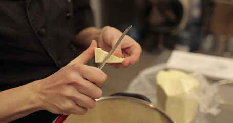 Close-up of a metal pan on a professional pastry hob. Melting butter, boiling caramel and mixing...