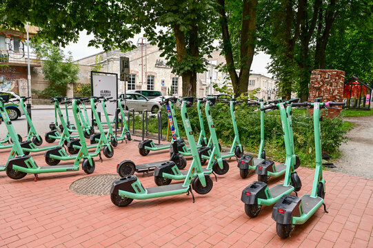 turquoise electric scooters or e-scooters from Bolt are lined up in a square waiting to be used, Tallinn, Estonia 18/08/2025