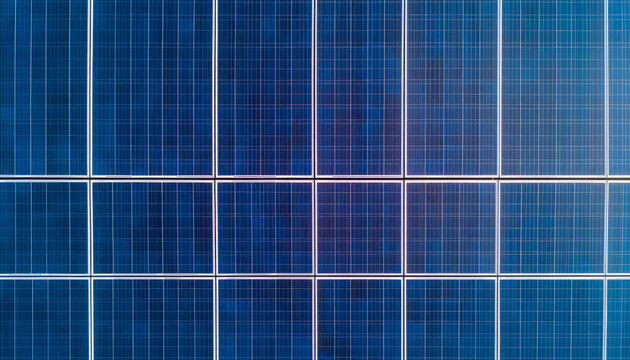 Solar Panel Array: A close-up view showcasing a grid of photovoltaic cells, capturing sunlight for renewable energy generation, highlighting clean technology.
