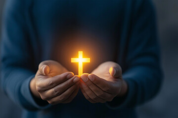 Individual holds glowing cross in hands, symbolizing faith and hope during a reflective moment