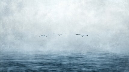 Obraz premium Three seagulls fly over a calm ocean