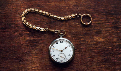 Vintage pocket watch on a chain with a metal bracelet and an analog dial. A vintage Chatelaine...