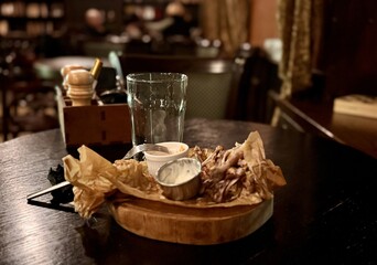 Enjoying a Delicious Meal accompanied by a Flavorful Dipping Sauce on a Rustic Table