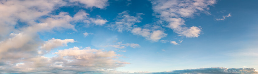 Serene Sky with White Clouds Over a Clear Afternoon Horizon