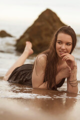 splashes of sea water around a slender girl in the sea