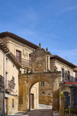 Fototapeta premium Manor house and heraldic shield over the entrance arch to the town of Labastida
